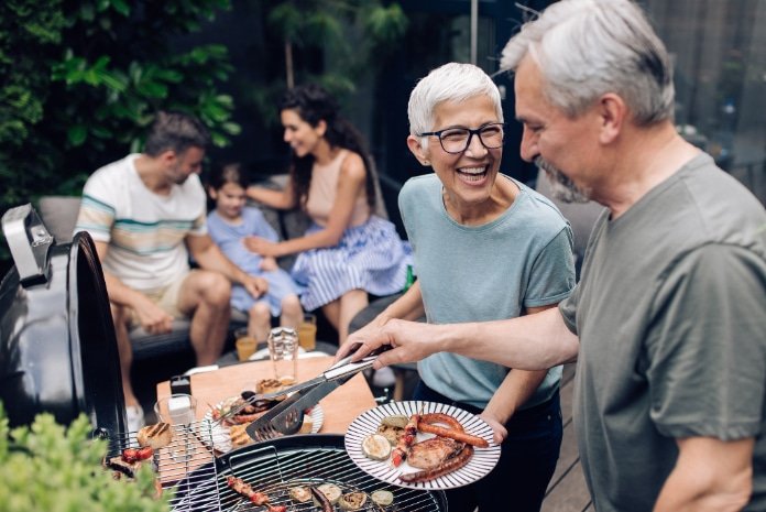 cheerful family is having a rest and having fun on the porch of a country house