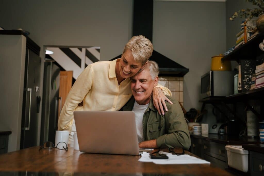 happy caucasian senior couple working from home