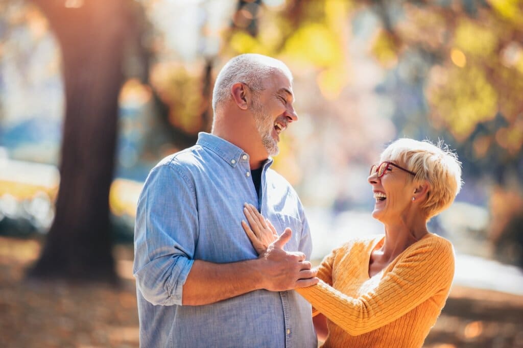 Active seniors on a walk in autumn forest